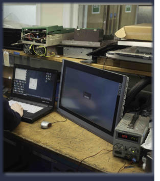 Neutronics engineer sourcing replacement components using diagnostic computer equipment
